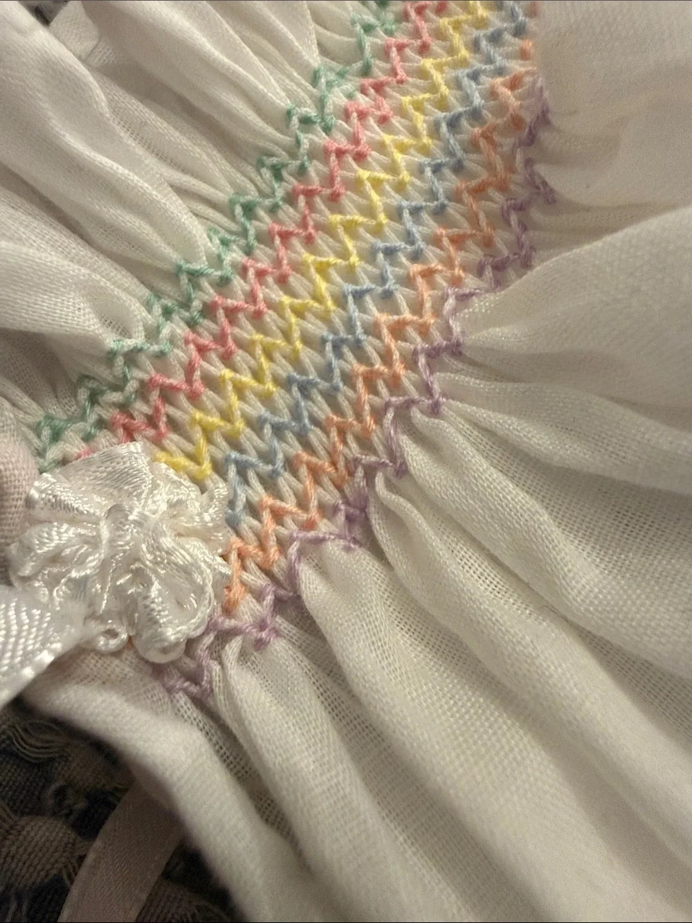 White Smocked Baby Bonnet with Pastel Rainbow Stitching